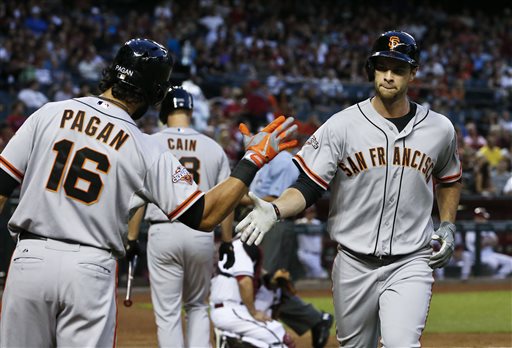 San Francisco Giants' Brandon Belt, right, shakes hands with teammate Angel Pagan (16) after hitting a home run against the Arizona Diamondbacks during the second inning of a baseball game, on Monday, April 29, 2013, in Phoenix. (AP Photo/Ross D. Franklin)