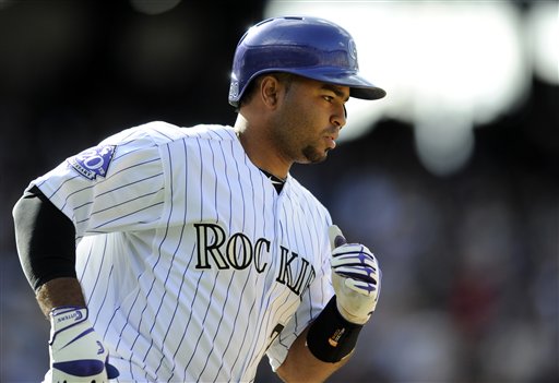 Colorado Rockies' Wilin Rosario (20)rounds the bases after hitting a three run home run against the San Diego Padres during the seventh inning of an MLB baseball game on Sunday, April 7, 2013, in Denver. (AP Photo/Jack Dempsey)