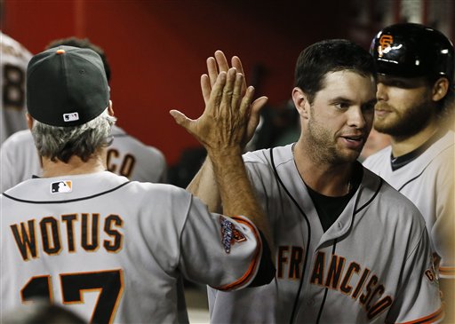 San Francisco Giants' Brandon Belt, right, gets a high-five from bench coach Ron Wotus after Belt hits a 3-run home run against the Arizona Diamondbacks during the eighth inning of a baseball game, on Wednesday, May 1, 2013, in Phoenix.  The Giants defeated the Diamondbacks 9-6. (AP Photo/Ross D. Franklin)