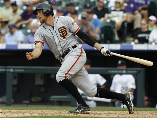San Francisco Giants' Hunter Pence singles against the Colorado Rockies in the ninth inning of the Giants' 5-2 victory in a baseball game in Denver on Sunday, June 30, 2013. (AP Photo/David Zalubowski)